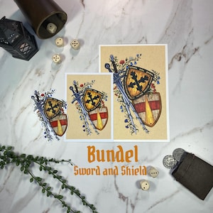 Könnte beinhalten: Ein Aufkleber und zwei Drucke mit einer Schwert- und Schildillustration mit Blumenakzenten, begleitet vom Text Bundel Sword and Shield, Würfeln, einem Lederbecher, einem kleinen Beutel und Münzen auf einer weißen Marmoroberfläche.