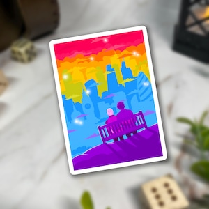 May include: A rectangular sticker featuring a stylized illustration of two figures sitting on a bench overlooking a city skyline. The artwork uses a vibrant gradient color palette of pink, orange, yellow, blue, and purple with small white star accents.