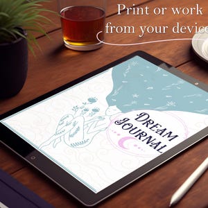 May include: A digital tablet displaying a printable dream journal cover with a blue and white illustration of a person with flowers and the text "DREAM JOURNAL".