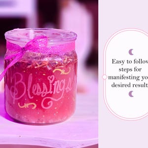 May include: A glass jar filled with a pink substance, adorned with a pink ribbon. The jar has the word "Blessings" written on it in cursive. The image also includes text that reads "Easy to follow steps for manifesting your desired results."
