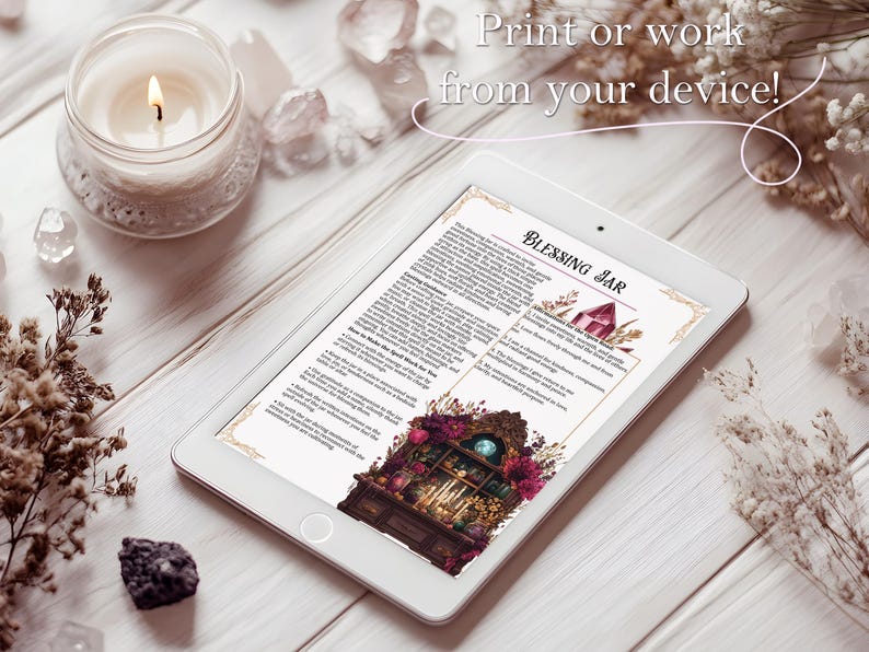 May include: A digital tablet displays a document titled "Blessing Jar" with illustrations of a barn and a cabinet. The tablet is on a light wood surface, surrounded by a lit candle, crystals, and dried flowers. Text on the screen reads "Print or work from your device!"