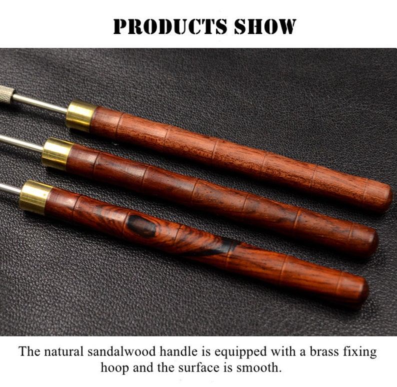 May include: Three wooden handled tools with brass accents. The tools have a natural sandalwood finish and are laid out on a dark brown surface.