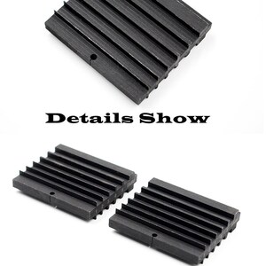 May include: Two black metal blocks with a series of ridges on one side. The blocks are designed to be used as a tool for shaping metal.