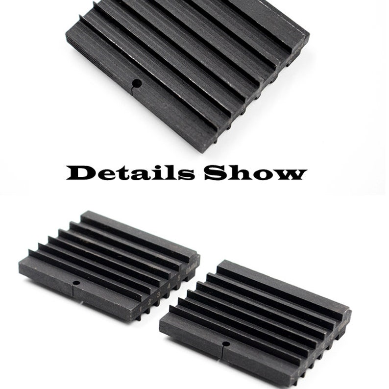 May include: Two black metal blocks with a series of ridges on one side. The blocks are designed to be used as a tool for shaping metal.