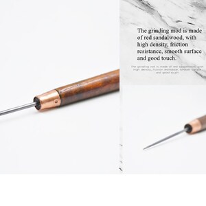 May include: A close-up of a wooden grinding rod with a copper tip and a thin metal blade. The grinding rod is made of red sandalwood, with high density, friction resistance, smooth surface and good touch.