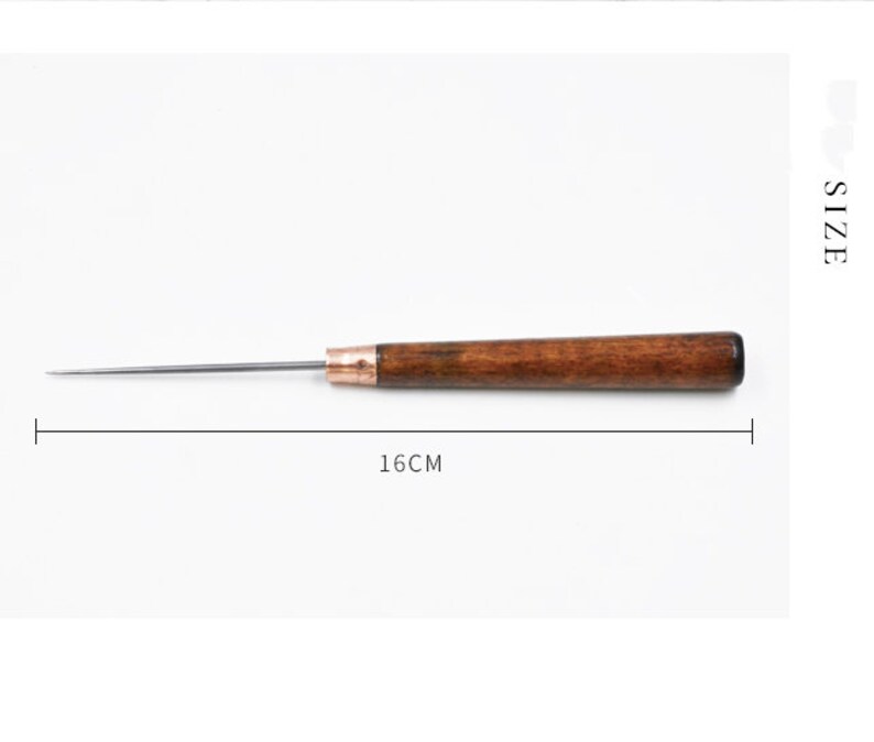 May include: A wooden-handled awl with a metal needle, measuring 16 inches in length. The awl is a tool used for piercing holes in leather or other materials.