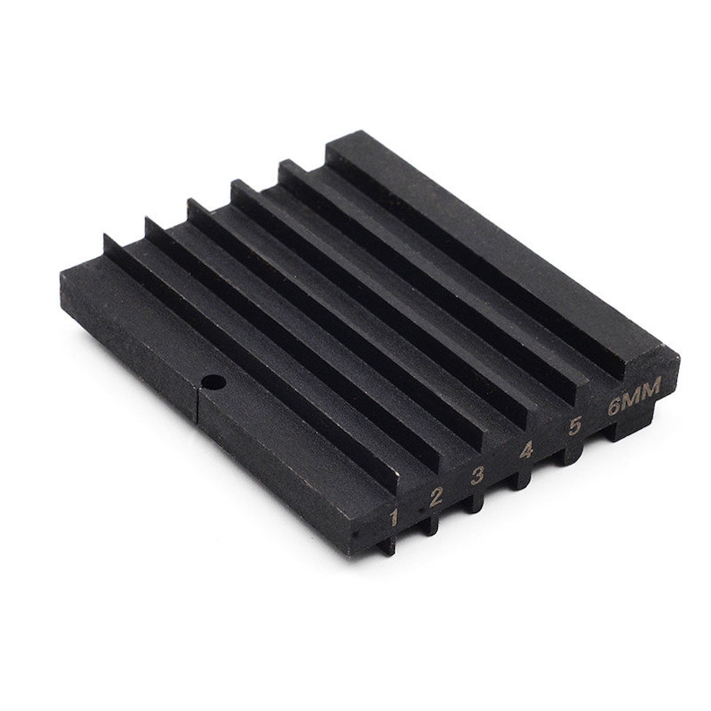 May include: Black metal gauge with six slots numbered 1 to 6 and 6MM. The gauge is used for measuring the diameter of round objects.