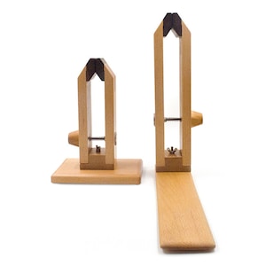 May include: Two wooden clamps with adjustable tightening mechanisms. The larger clamp has a longer base and the smaller clamp has a shorter base.