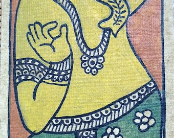 May include: A hand-painted illustration of the Hindu deity Ganesha. The image depicts Ganesha in a yellow robe with green and black patterned pants. He has a large head with an elephant trunk and a crown. The background is orange.