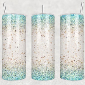 May include: Three stainless steel tumblers with a glitter design. The tumblers have a white base with a gradient of blue and green glitter.