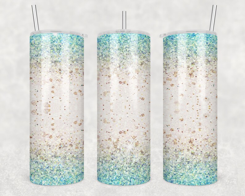 May include: Three stainless steel tumblers with a glitter design. The tumblers have a white base with a gradient of blue and green glitter.