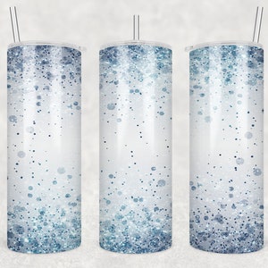May include: Three stainless steel tumblers with lids and straws. The tumblers have a white background with a gradient of blue glitter.