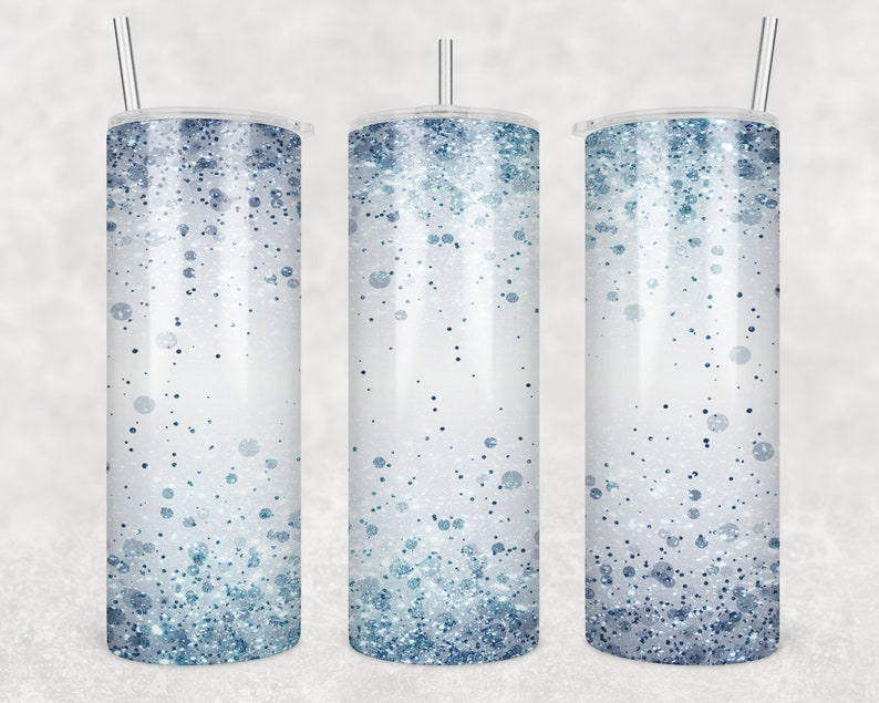 May include: Three stainless steel tumblers with lids and straws. The tumblers have a white background with a gradient of blue glitter.