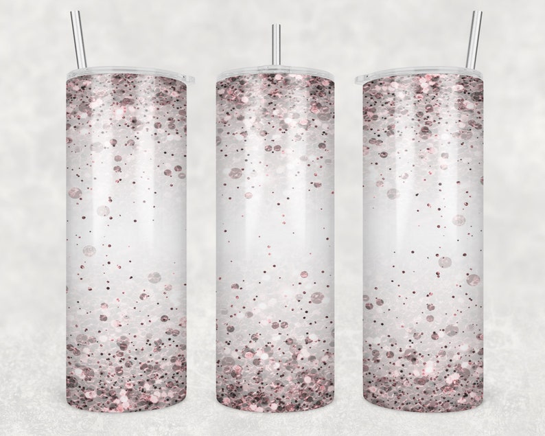 May include: Three stainless steel tumblers with a white background and a pink glitter design. The tumblers have lids and straws.