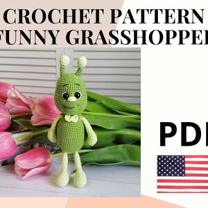 May include: Crochet pattern for a green grasshopper amigurumi toy. The pattern is available as a PDF download. The image shows the finished toy in front of a bouquet of pink tulips.