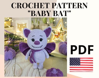 May include: Crochet pattern for a purple baby bat amigurumi toy. The pattern is available as a PDF download. The image shows the finished toy with a scarf and wings.