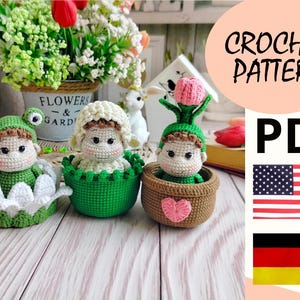 May include: Crochet pattern PDF for three amigurumi dolls in flower pots. The dolls are a frog, a flower, and a person. The pattern is available in English and German.