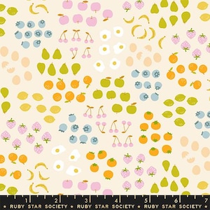 May include: A cream-colored fabric with a repeating pattern of various fruits. The design includes pink apples, yellow bananas, green pears, orange oranges, and blue blueberries. The text "RUBY STAR SOCIETY" is at the bottom.