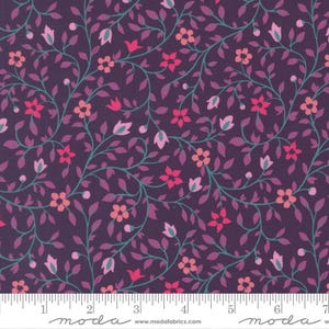 May include: A fabric with a dark purple background, featuring a repeating floral pattern. The design includes pink, coral, and light purple flowers, with teal-colored vines and leaves. The fabric has a ruler along the bottom with the word "moda".