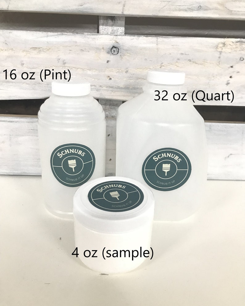 May include: Three white plastic containers of paint, labeled 16 oz (Pint), 32 oz (Quart), and 4 oz (sample). Each container has a white lid and a teal and white label with the text "SCHNUBS" and "SCHNUB IT UP".