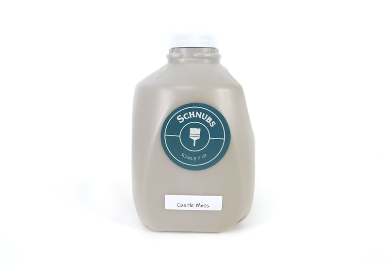May include: A light gray paint container with a white cap. The container has a teal and white label that says "Schnubs" and "Schnub it up". A smaller label at the bottom says "Castle Moss".