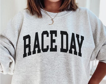 May include: Gray sweatshirt with the text "RACE DAY" in black block letters.