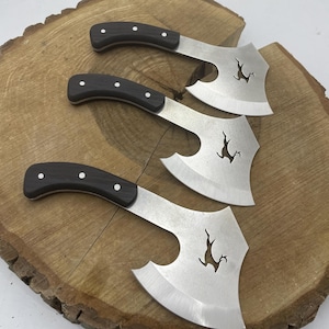 May include: Three small axes with black handles and a deer silhouette cut out of the blade.