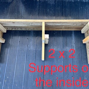 May include: A wooden shelf with two 2x2 supports on the inside. The shelf is made of reclaimed wood and has a rustic look.