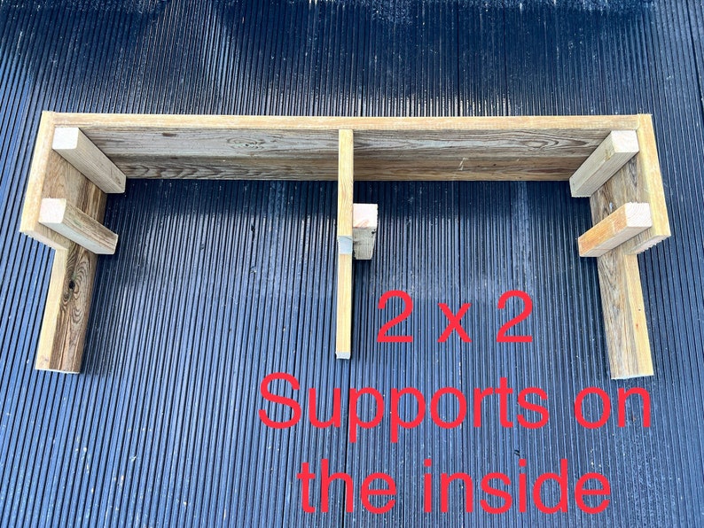 May include: A wooden shelf with two 2x2 supports on the inside. The shelf is made of reclaimed wood and has a rustic look.