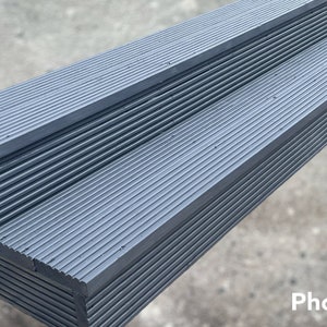 May include: Two-step gray plastic platform with a ribbed surface. The platform is designed for outdoor use.