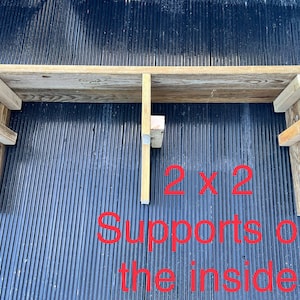May include: A wooden shelf with two 2x2 supports on the inside. The shelf is made of reclaimed wood and has a rustic look.
