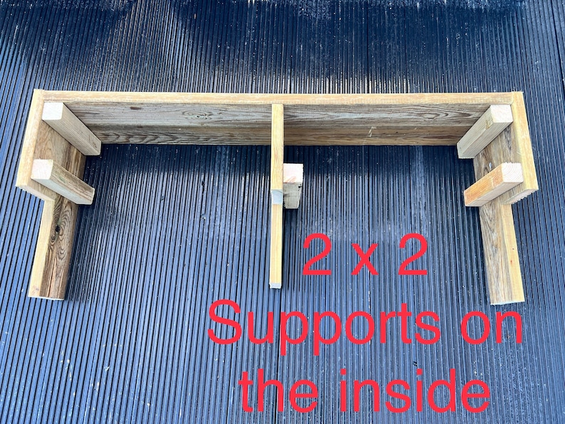 May include: A wooden shelf with two 2x2 supports on the inside. The shelf is made of reclaimed wood and has a rustic look.