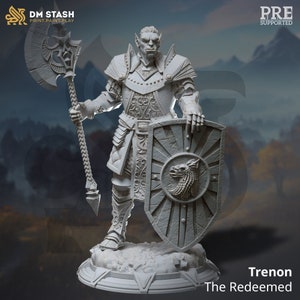 May include: A gray, detailed miniature of a warrior with a wolf head on their shield. The warrior is holding a large axe and is wearing armor with intricate designs. The miniature is standing on a circular base with a design on it. The text "Trenon The Redeemed" is below the miniature.