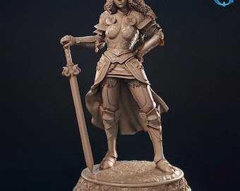 May include: A detailed sculpture of a female warrior in ornate armor, holding a sword. The figure stands on a decorative base with floral patterns. The armor features intricate designs, and the overall color is a muted bronze.