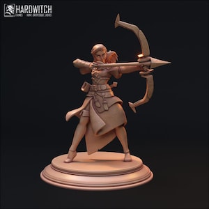 May include: A tan-colored figurine of an archer aiming a bow and arrow. The archer is wearing a detailed outfit and standing on a circular base. The Hardwitch Games logo is in the upper left corner.
