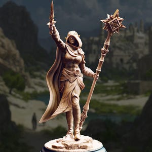 May include: A detailed figurine of a hooded figure holding a sword and staff. The figure is wearing a cloak and armor, with intricate details on the clothing and weapons. The staff has a star-shaped top. The color is a light brown.