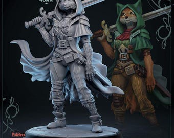 May include: A grey painted miniature figurine of a cat-like creature wearing a hooded cloak and holding a sword. The figurine is standing on a round base. The text "40mm" is visible in the image. The text "The Beast of Stragovir" is visible in the image. The text "Marie Greenhood" is visible in the image. The text "25mm Base" is visible in the image.