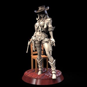 May include: A light-colored figurine of a cowgirl wearing a wide-brimmed hat, a collared jacket, and shorts. The figure has a belt with a skull buckle, two holstered revolvers, and tall boots. It stands on a circular wooden-plank base near a chair.