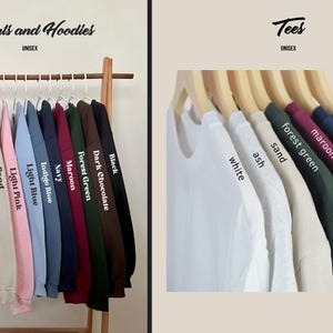 May include: A display of unisex apparel, including sweatshirts and hoodies, and t-shirts, in various colors. The sweatshirts and hoodies are on the left, and the t-shirts are on the right. Colors include white, ash, sand, light pink, light blue, indigo blue, navy, maroon, forest green, dark chocolate, and black.