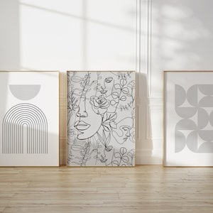 May include: Three framed prints with minimalist line art designs. The center print features a pattern of overlapping faces and floral elements. The print on the left features a gray arch with vertical lines. The print on the right features a pattern of overlapping gray circles.