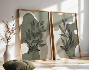 Peut inclure: Deux affiches murales rectangulaires dans des cadres en bois clair représentant des branches feuillues en lignes noires sur des formes abstraites vert sauge et crème. Les impressions sont présentées côte à côte avec un motif botanique.
