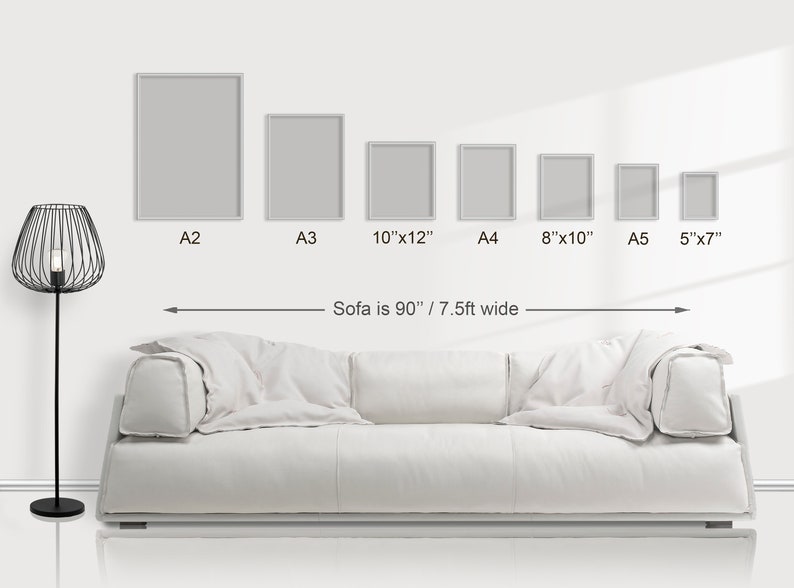 May include: A white sofa is 90 inches wide, with six different sized frames hanging on the wall above it. The frames are labelled with their sizes: A2, A3, 10"x12", A4, 8"x10", and A5 5"x7".