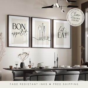 May include: Three black and white framed prints with kitchen-themed text and illustrations. The prints read "Bon Appetit", "Let's Eat", and a line drawing of a fork, knife, and spoon.