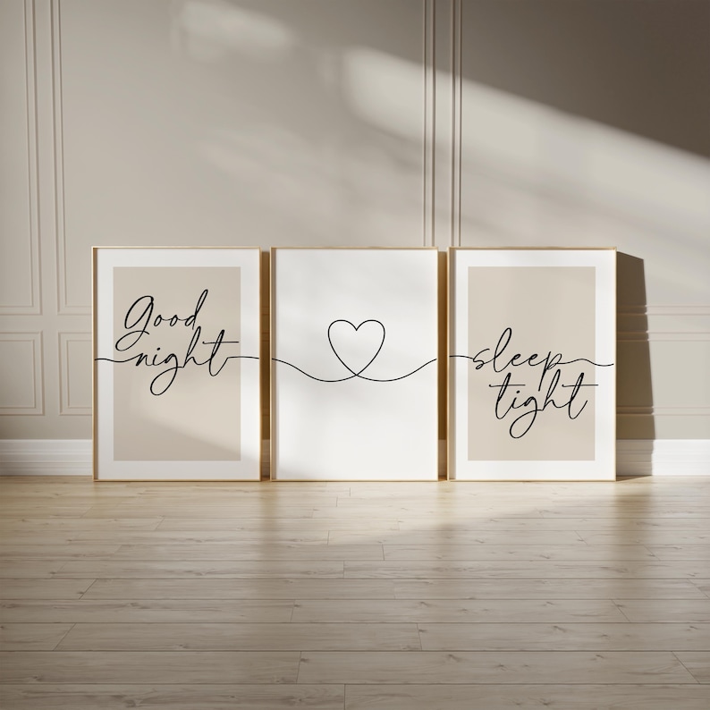 May include: Three framed wall art prints. The left and right prints have a beige background with the words "Good night" and "sleep tight" in black script. The center print has a white background with a black heart outline.