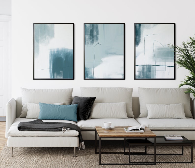 set of 3 duck egg blue colour abstract wall art prints with blue brushstrokes and line art details