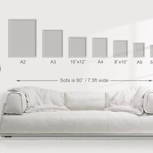 May include: A white sofa is 90 inches wide, with six different sized frames hanging on the wall above it. The frames are labeled with their sizes: A2, A3, 10"x12", A4, 8"x10", and A5 5"x7".