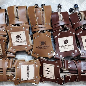 camera harness in leather with personalized logo in Dark brown color