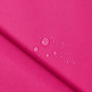 May include: Close-up of a vibrant fuchsia fabric with a subtle texture. Several water droplets are scattered across the surface, indicating a waterproof or water-resistant material. The fabric is folded, showing the weave and depth of the material.