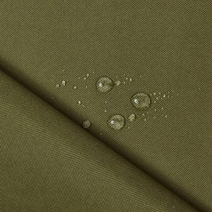 May include: Close-up of a green fabric with water droplets on the surface. The fabric has a textured weave and appears to be water-resistant.