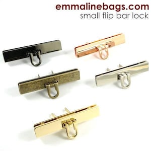 May include: Four small flip bar locks in different finishes: antique brass, gold, silver, and copper. Each lock has a rectangular shape with a small loop on the end.
